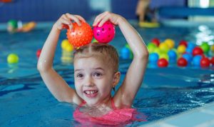 Preschool girl learning to swim